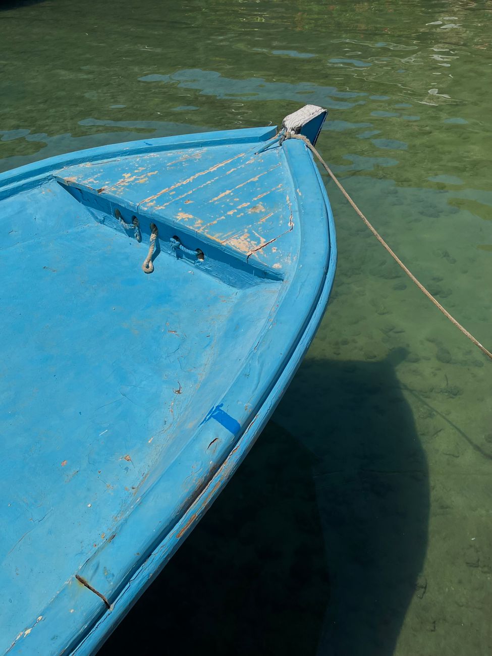 Quiet sail boat floating on crystal turquoise waters